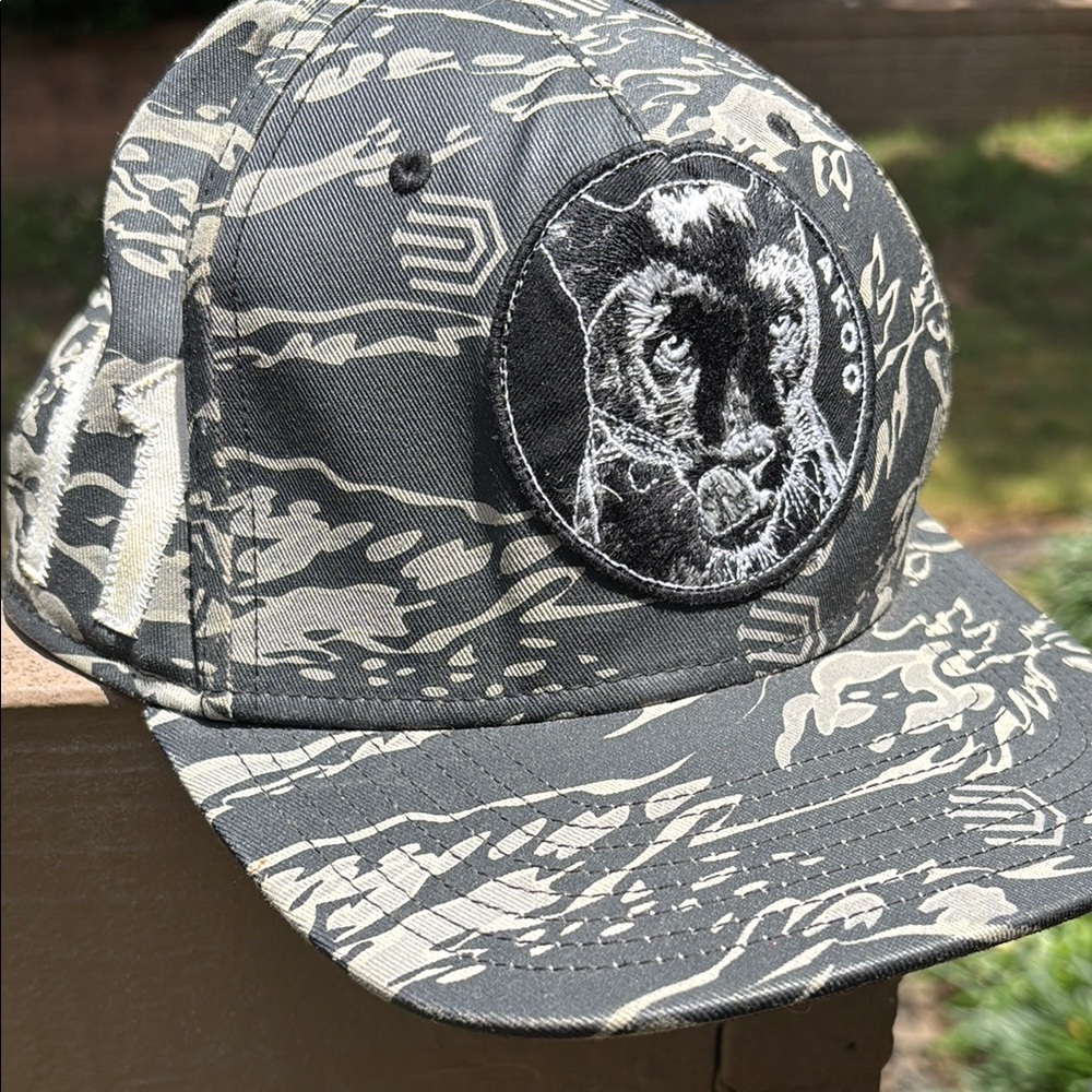 Akoo Gray and Cream Panther Trucker hat